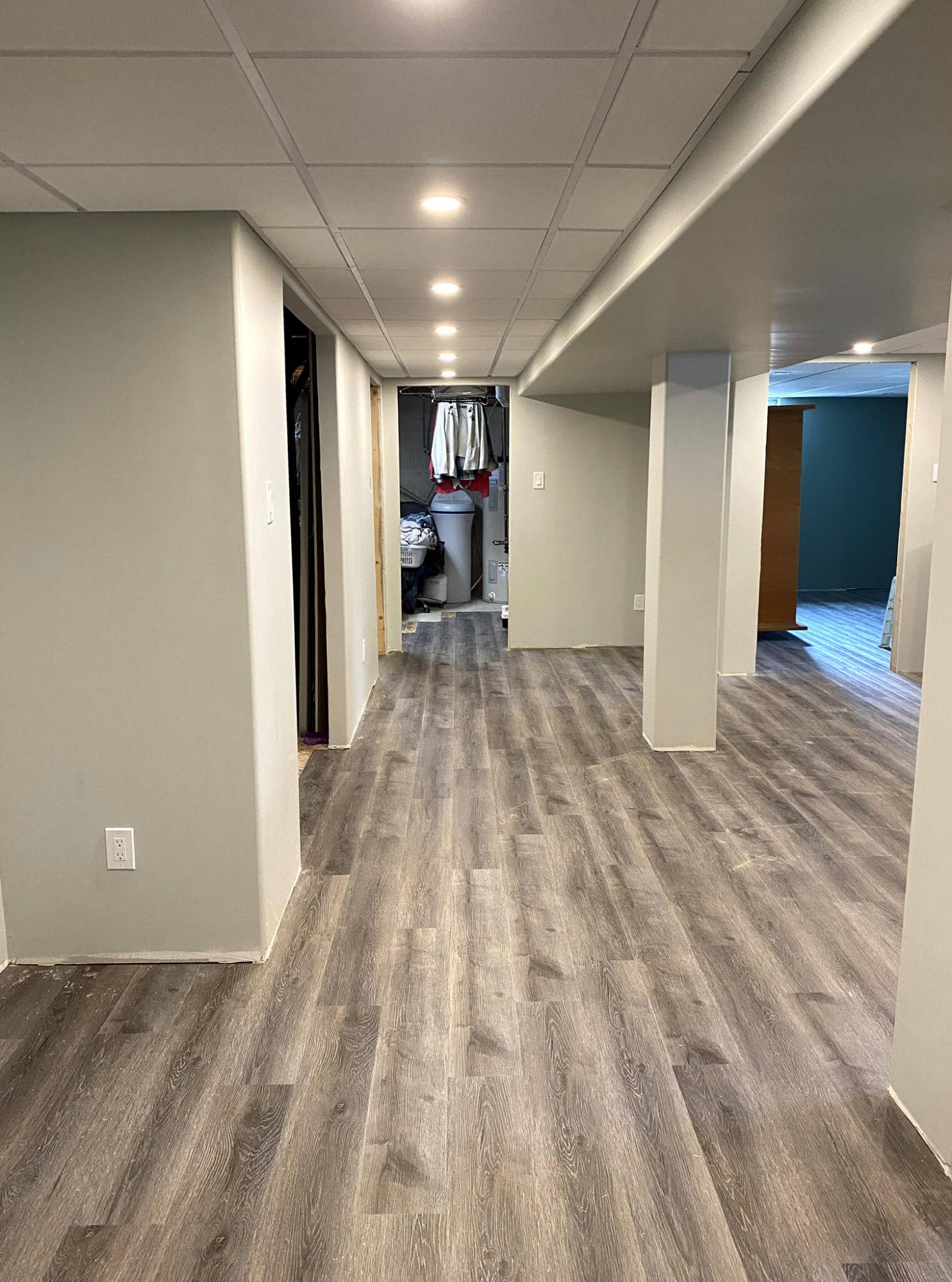 <p>The orientation of the flooring was established by setting the vinyl plank parallel to the long of the main rec-room and hallway.</p>