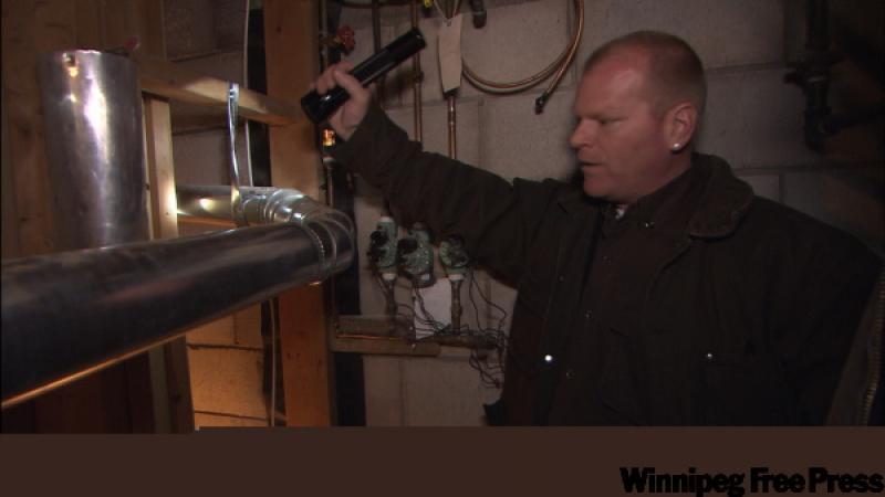 Mike Holmes checks out a customer's furnace.