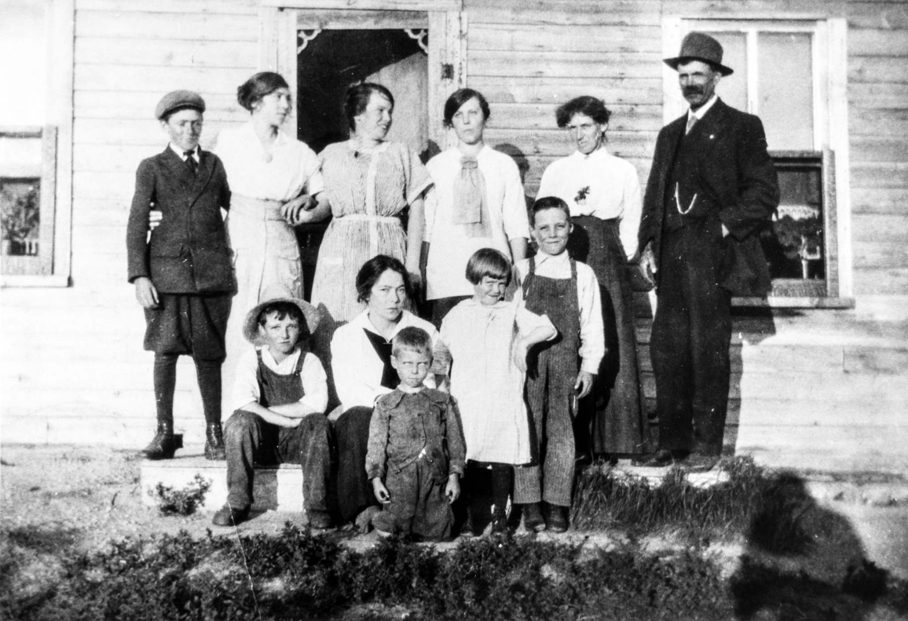 <p>Supplied photos </p><p>Grandpa and Grandma Mustard (back row from right) with their brood in front of the house Grandpa Mustard built on the bald prairie back in the 1880s.</p>