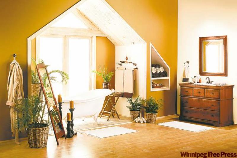 The addition of several leafy house plants provides a tropical feel and also softens the tub area, which could look cavernous if left unadorned. The wicker and bamboo accents provide a casual flavour that works well with the wood flooring.