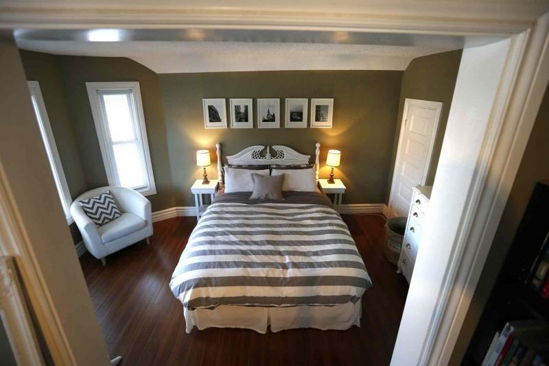 The master suite is loaded with contemporary design elements and bathed in light thanks to a bay window. 