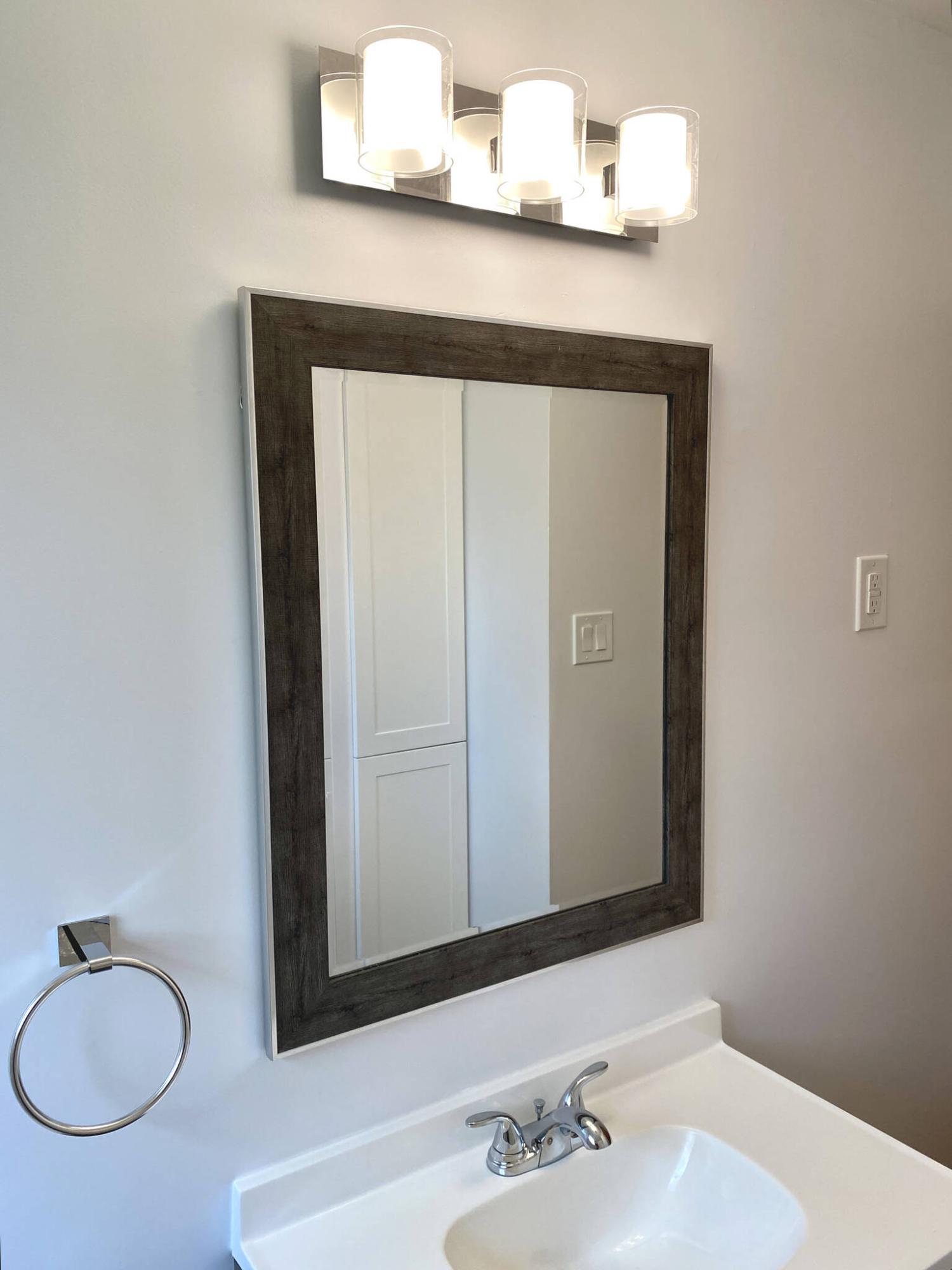  <p>The new light fixture was moved to align with the mirror and vanity.</p> 