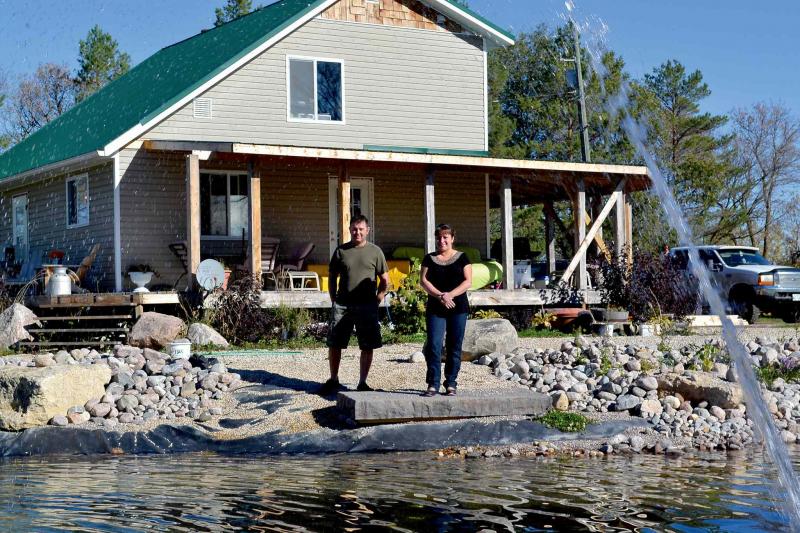 Martin and Melissa with partially renovated house in background.