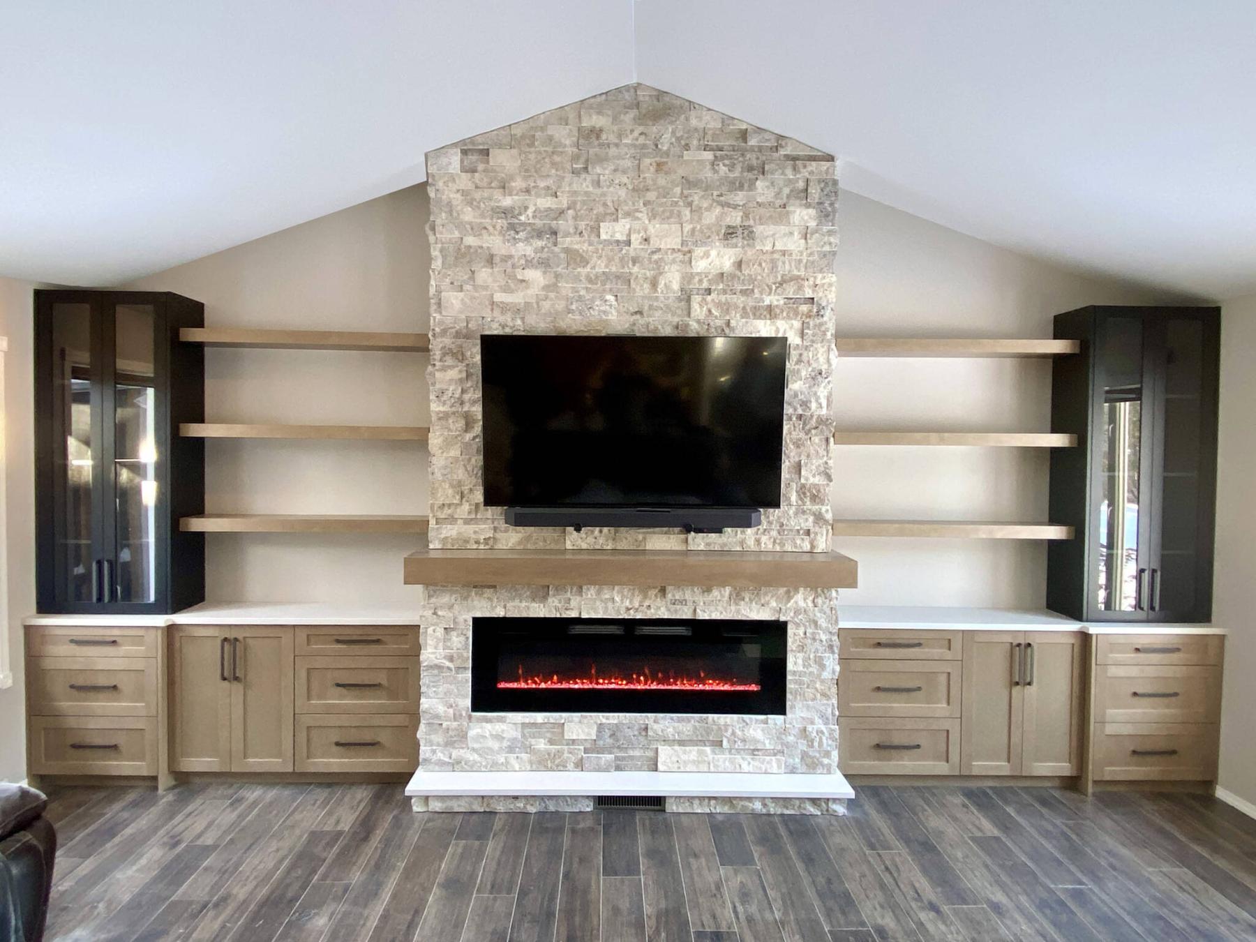  <p>Photos by Marc LaBossiere / Free Press</p>
                                <p>The feature fireplace wall spans 19 feet, and showcases a stone-clad fireplace stack, hearth and mantle, with symmetrical cabinetry and floating shelves on either side.</p> 
