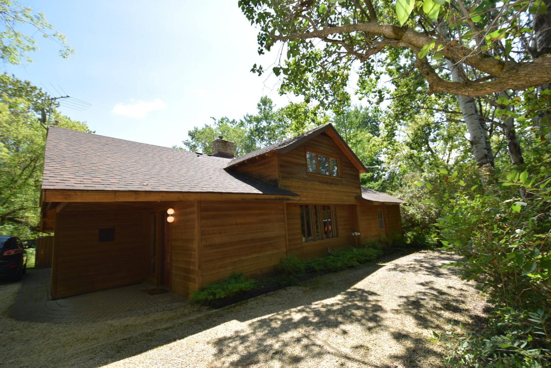 <p>Photos by Todd Lewys / Free Press</p>
                                <p>Surrounded by mature trees, this home is a rustic masterpiece.</p> 