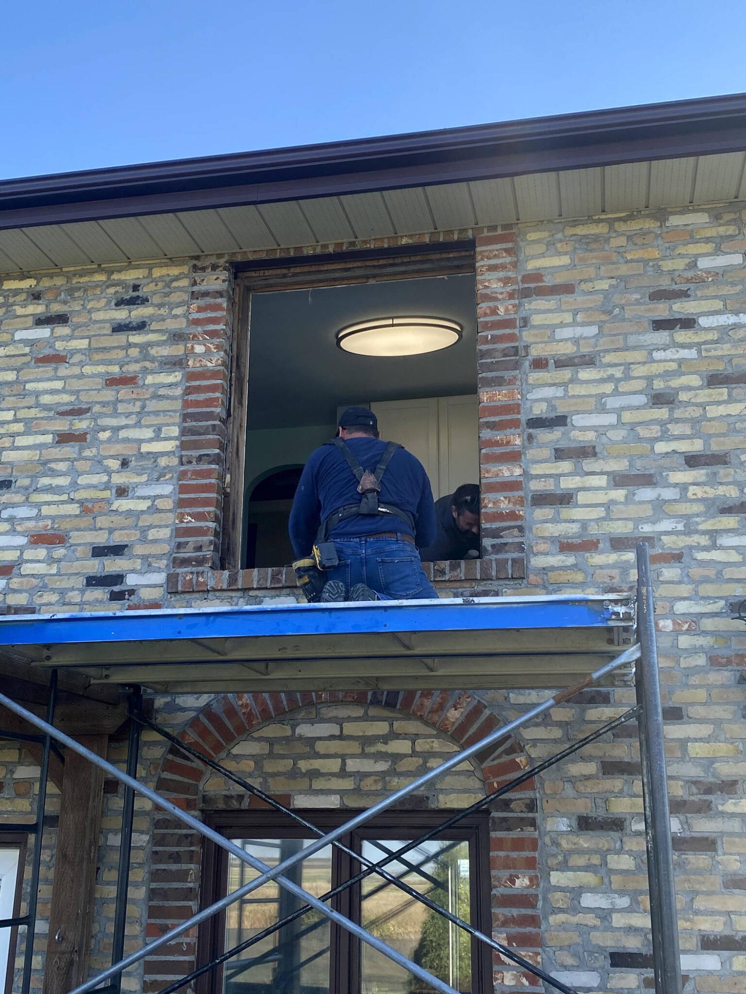  <p>Photos by Marc LaBossiere / Free Press</p>
                                <p>To tackle the second-floor windows, scaffolding is positioned just below the window location to ease removal of the old and insertion of the new.</p> 