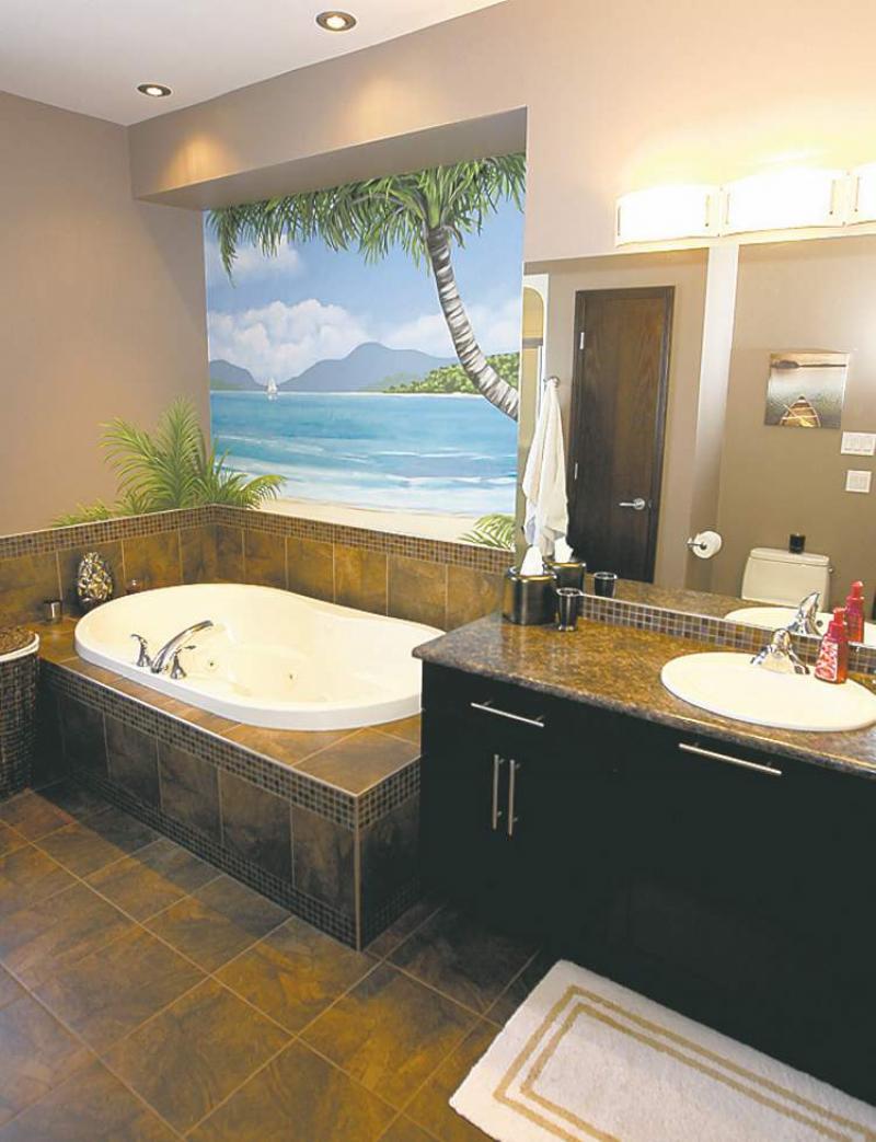 A six-foot jetted soaker tub is set in dark-brown tiled ensuite that includes a four-foot shower with a rain shower head.