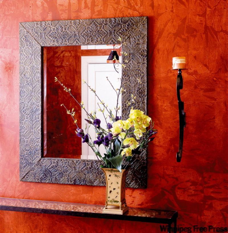 Create this faux fine-tooled leather mirror frame with a bit of paint and wallpaper. 