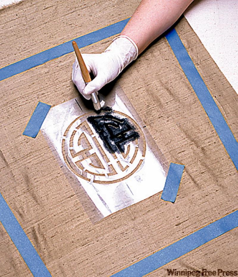 Dip the stencil brush in the fabric paint and rub most of it off on a paper towel. Then use a circular motion to work the paint into the fabric fibres. Once the paint has dried, heat-set it with an iron according to manufacturer's instructions. When you have attached the new covers, apply a protective fabric spray.