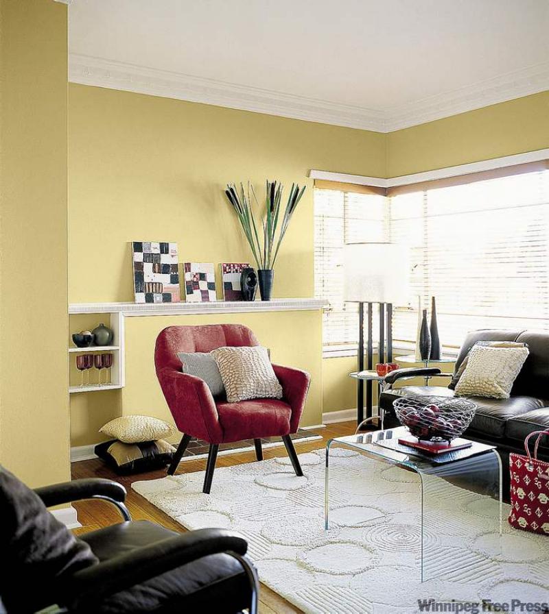 Designers made a focal point of the unusual wall by placing a red chair in front of it along with colourful artwork and tall reeds.