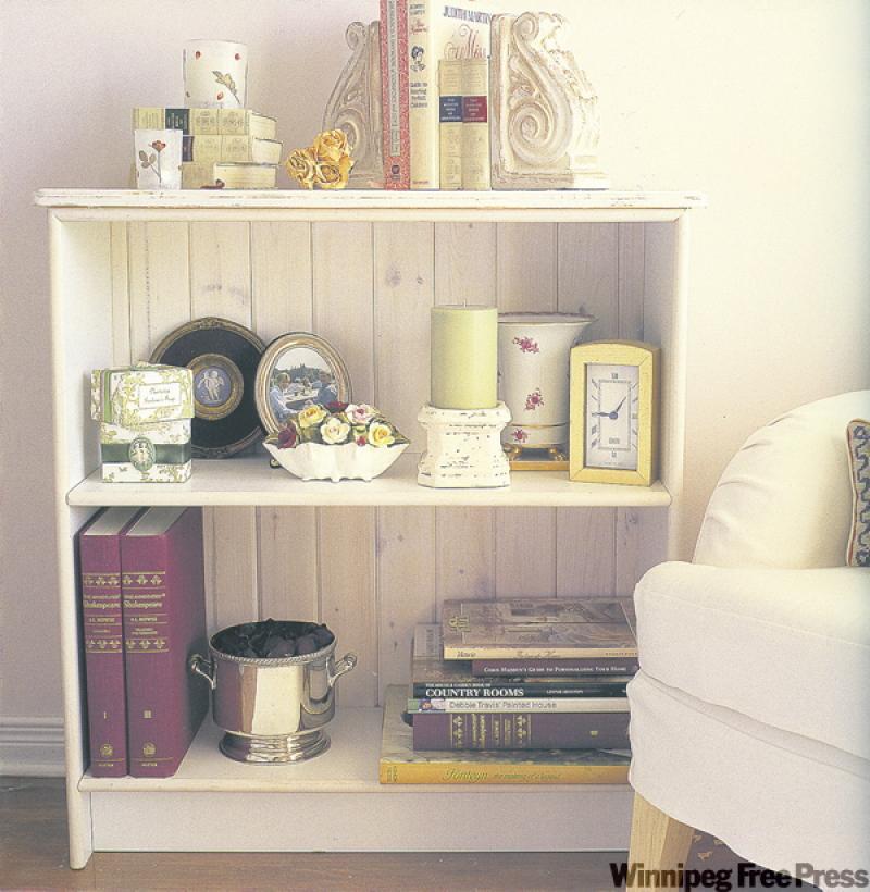 Adding softly glazed wainscoting to the back of a basic shelving unit transforms a boring piece into a charming display area.