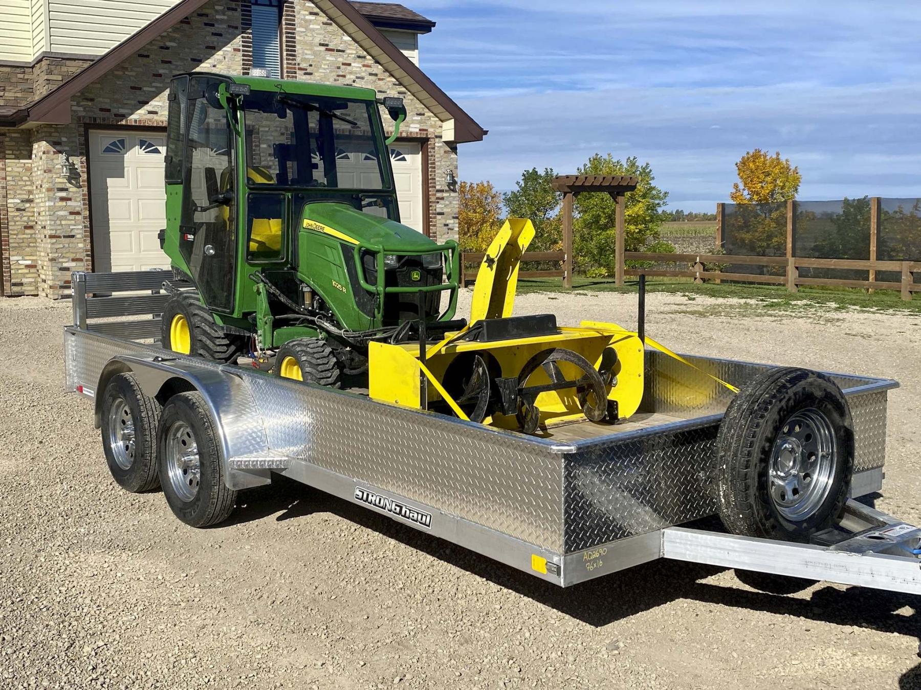 <p>Photos by Marc LaBossiere / Winnipeg Free Press</p><p>The Stronghaul 76-inch by 16-foot aluminum utility trailer with 3,500-pound tandem axles. Fifteen-inch sides and a bifold ramp easily cater to the John Deere 1025R.</p></p>