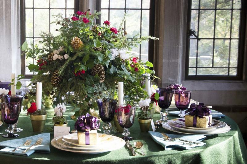 <p>Michael Devine</p><p>A table by Michael Devine is set with his line of hand-painted china, with vintage glassware and flatware on a forest green felt tablecloth.</p>