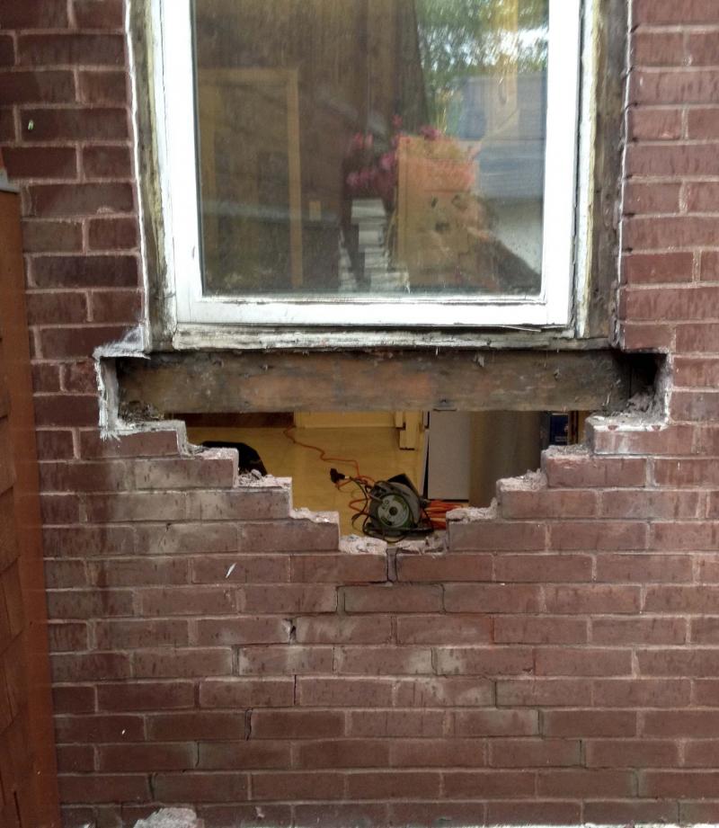 <p>The initial stages of brick removal during the wall breach to create the new back door.</p>