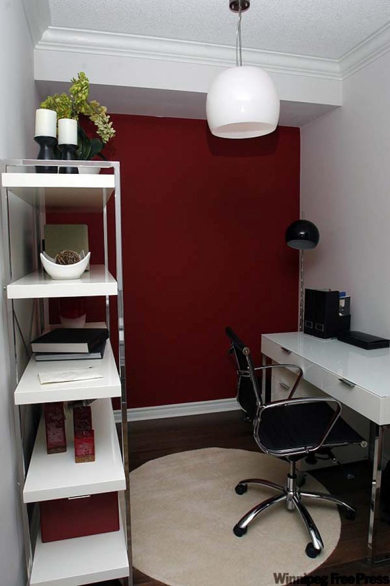Minimal lines of the sleek desk and shelving unit allow the strong back wall colour to dominate the space.
