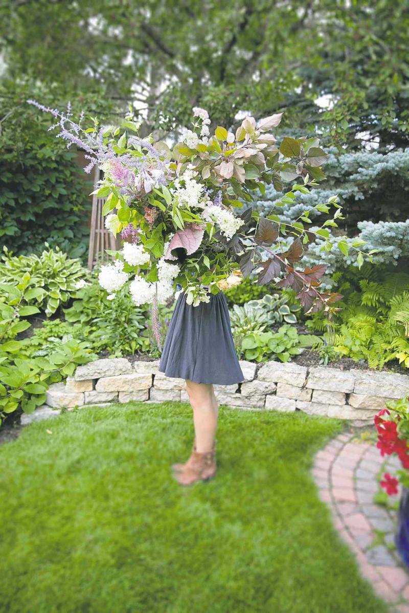 ThisSweetLovePhotography 

With an armful of foraged plants, Heather Page is ready to create a bouquet. As for the beds, they donï¿½t miss a few snips here and there.