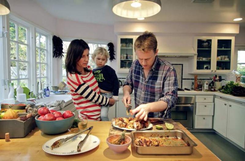 Matthew Armistead, the head chef at Soho House, fixes a platter of chicken piri piri under the eyes of wife Shelley and three-year-old son Isaac in his home kitchen.