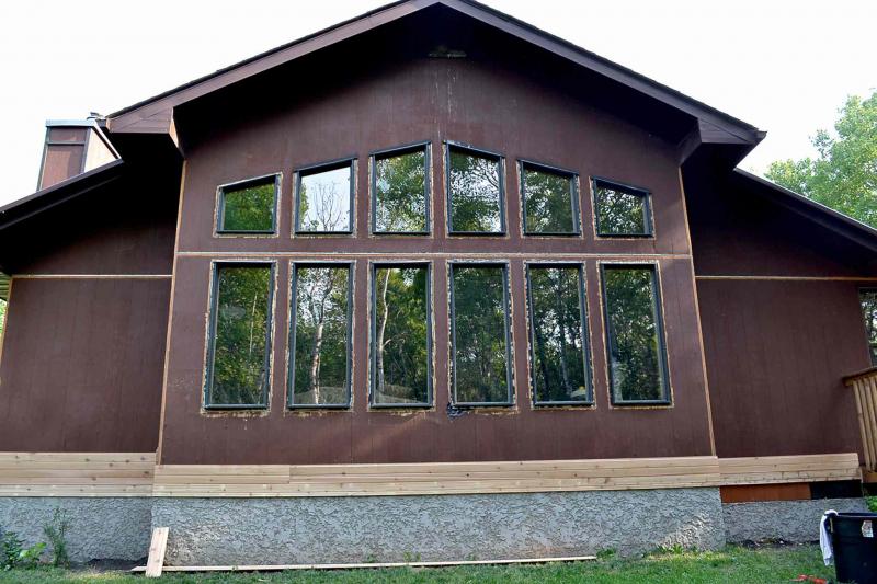 Front elevation of the home with original ranch wall siding.