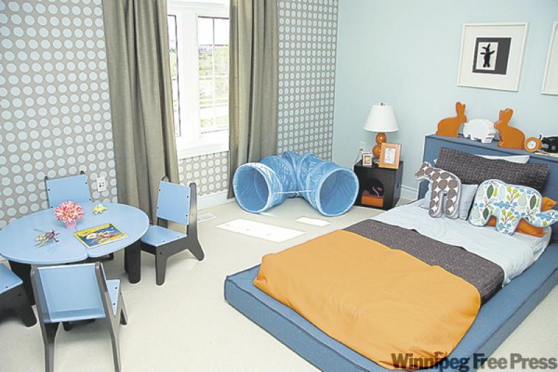 The neutral effect of light blue and gray walls is livened up in this boy's bedroom with high energy orange.