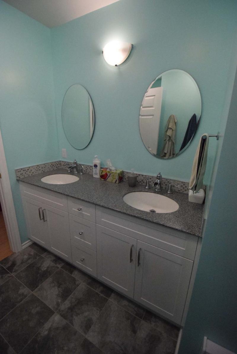 <p>Todd Lewys / Winnipeg Free Press</p><p>Style and utility meet with a large white vanity featuring loads of storage, dual sinks, tile trim and a grey countertop.</p>