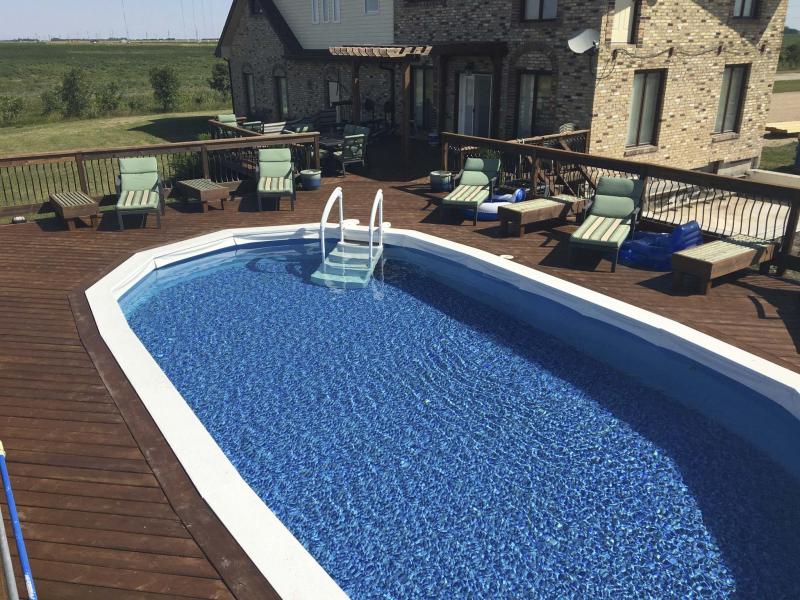 <p>Marc LaBossiere / Winnipeg Free Press</p><p>In top photo, Marc LaBossiere installs his new pool liner. Above, the finished job is an upgrade from the original and showcases a rock design on the liner floor.</p>