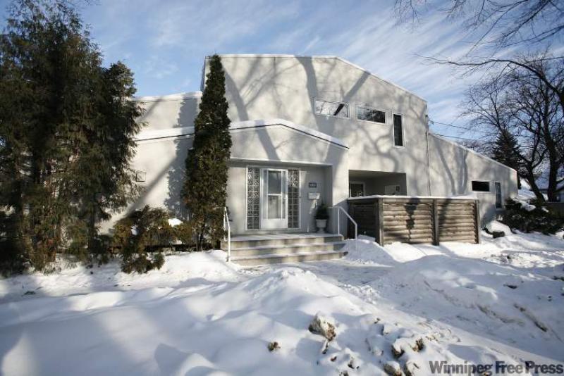 Although 402 Brock is a modern design, it fits in with the more classical nature of the neighbourhood. Builders maintained the character of the lot, choosing to keep a stand of pines that fronts the home.