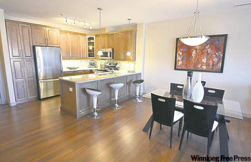 The well-appointed kitchen/dining area with laminate hardwoods, maple cabinets and granite counter tops.