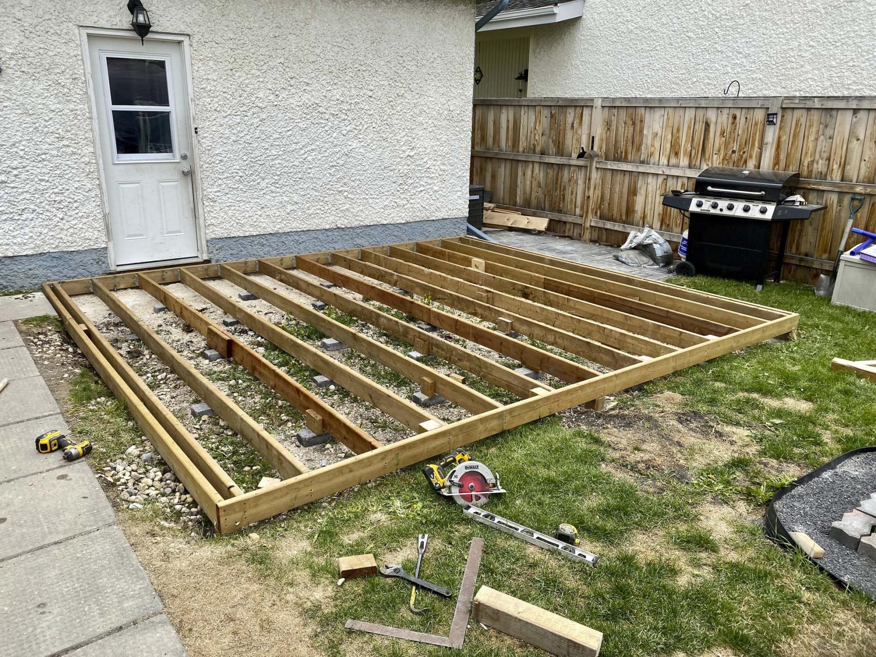 <p>The low-level deck is framed with 2x6 joists and supported with paving stones.</p>