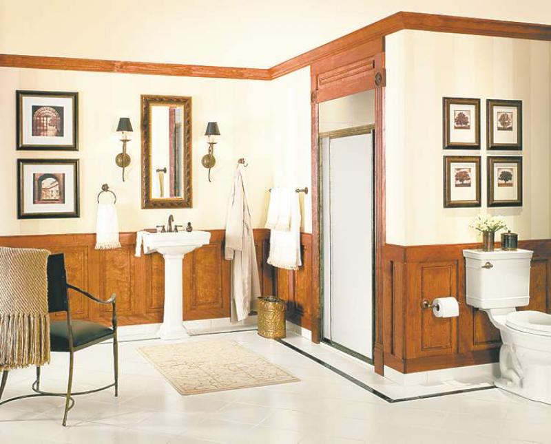 The light-coloured wallpaper, boasting a soft, vertical stripe on the top half of the room, keeps things light and fresh while the dark accents provide drama.