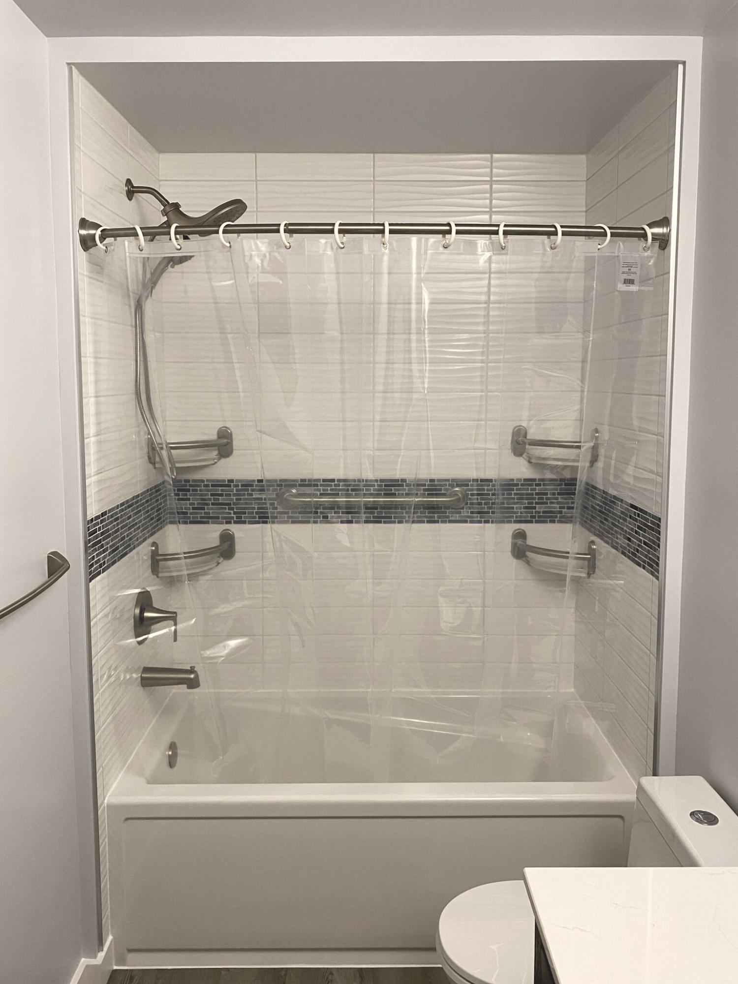  <p>photos by Marc LaBossiere / Winnipeg Free Press</p>
                                <p>To meet the 60-inch gap requirement for a proper tub installation, the walls were built out and a slim bulkhead was created for an esthetically cohesive look creating a cove for the tub-shower area.</p> 