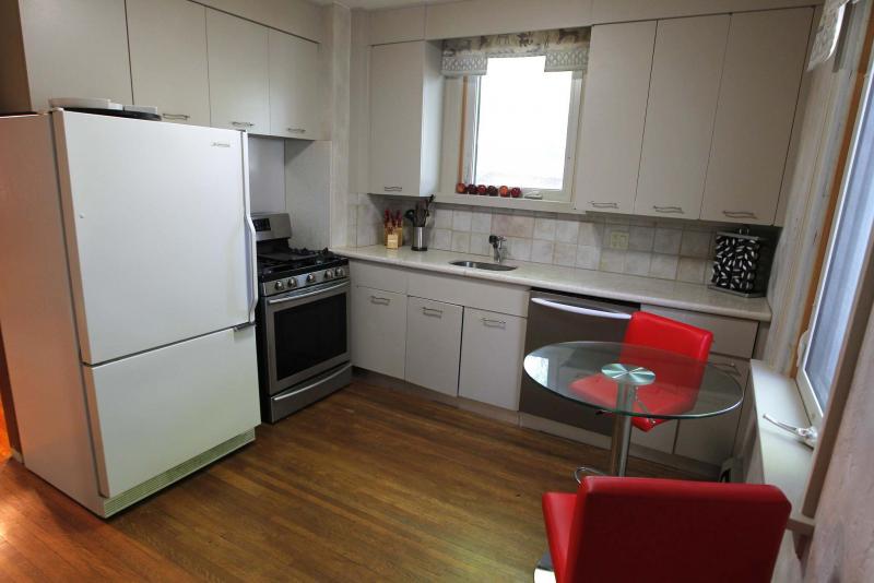 <p>The kitchen features modern cabinets and newer granite countertops. </p>