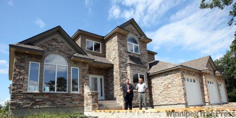 Realtor Jeff Stern, left, and Sapphire Homes owner Wes Geddert outside the home at 16 Medinah in La Salle. (Photos by Ken Gigliotti/Winnipeg Free Press)
