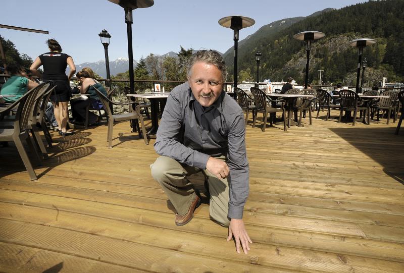 Chris Gaston with the annabilis fir deck at the Boathouse restaurant in West Van: 'a solid wood product that looks nicer for longer' .