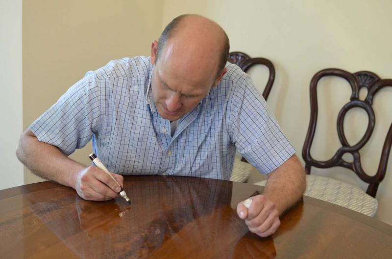 <p>Brad Urban / Washington Post</p><p>For tiny nicks and scratches, Keith Fritz sometimes uses a special furniture stain marker.</p>