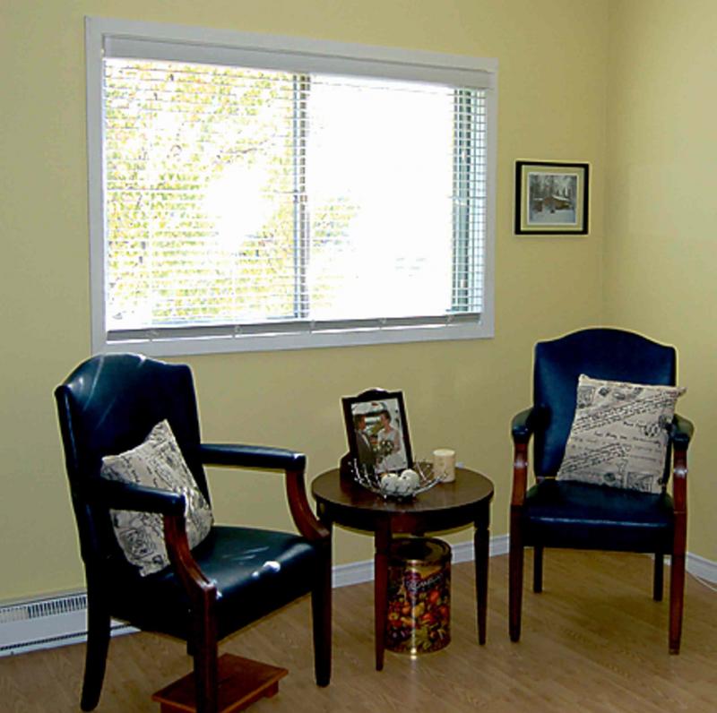 Above, Zone 2 is a great place to sit and read a book. At right, Zone 3 boasts an accent chair  in turquoise brocade.