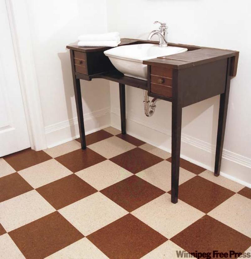 Light and dark tiles in a checkerboard design make bathroom warm and stylish.