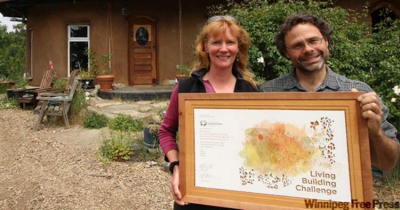 Ann and Gord Baird stand with their award in front of their home in Victoria, B.C. 