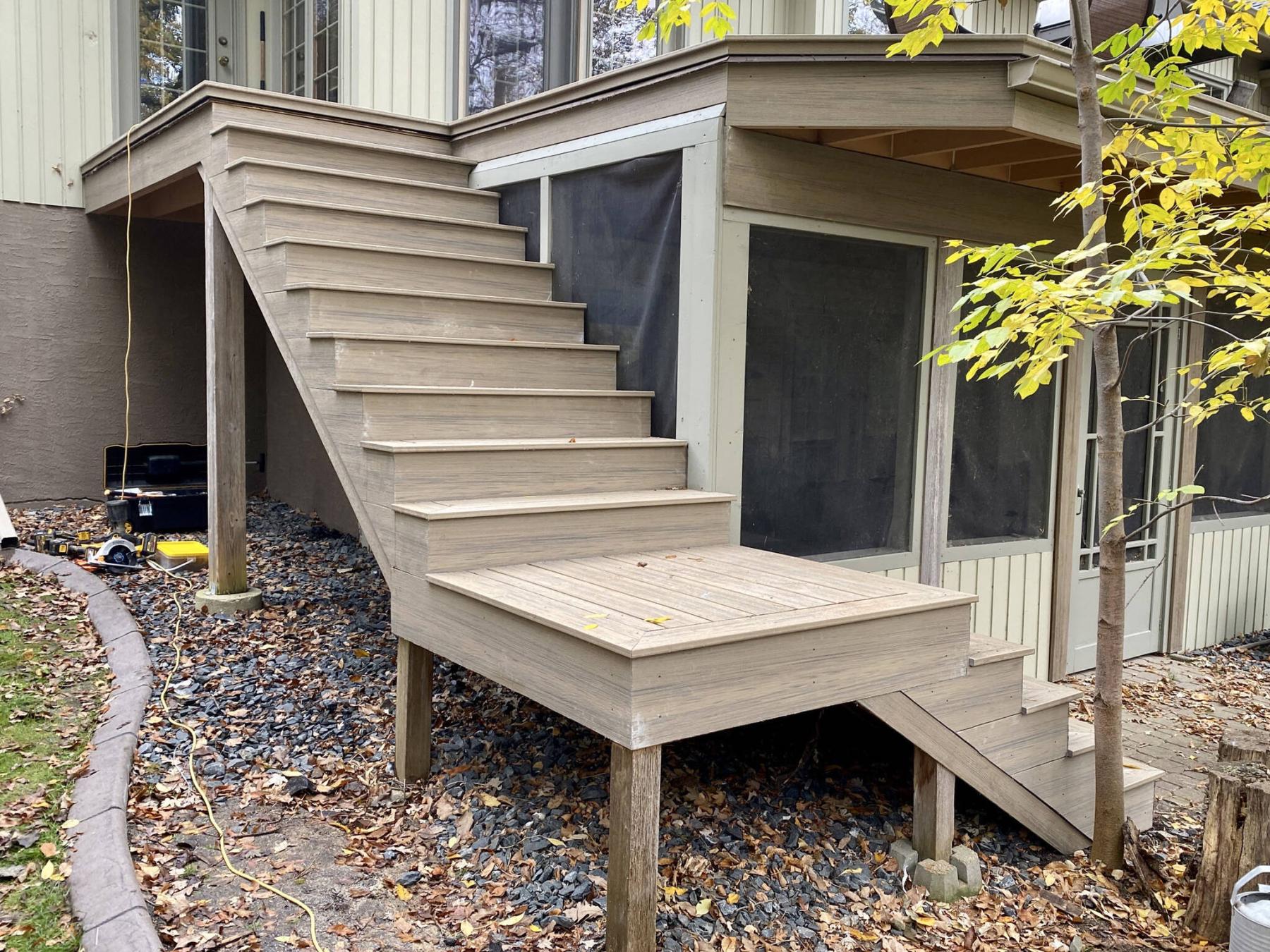  <p>Composite decking is used to decoratively sheathe an existing balcony deck and staircase, with glass railings to be installed.</p> 