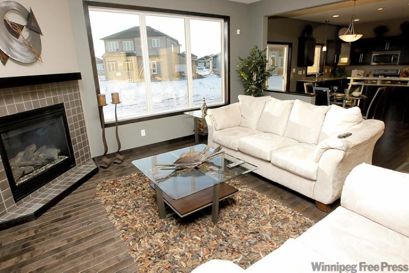 A tiled fireplace in the showhome serves as a focal point in the great room.