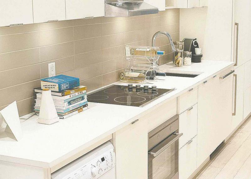 The kitchen has decent counter space and storage and a nifty dual-spray pull-down high arc faucet