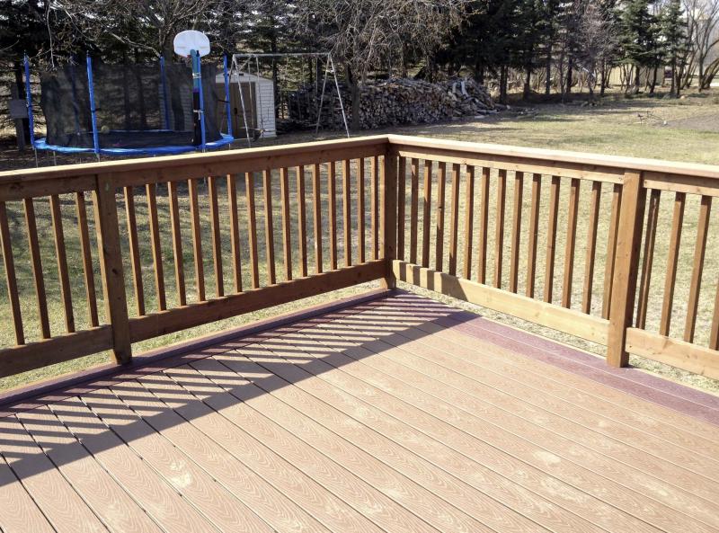 <p>Tandem burgundy TREX boards serve as the perimeter picture-framing, with light brown TREX boards within, parallel to the backside of the house.</p>