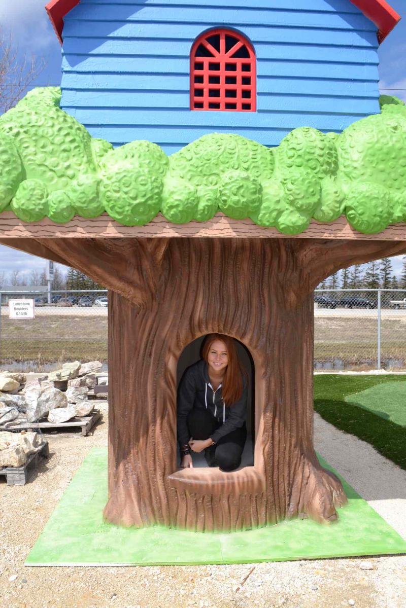 Tara Roemermann of J&D Penner investigates the inside of a two-tier tree playhouse for kids of all ages manufactured by the company.