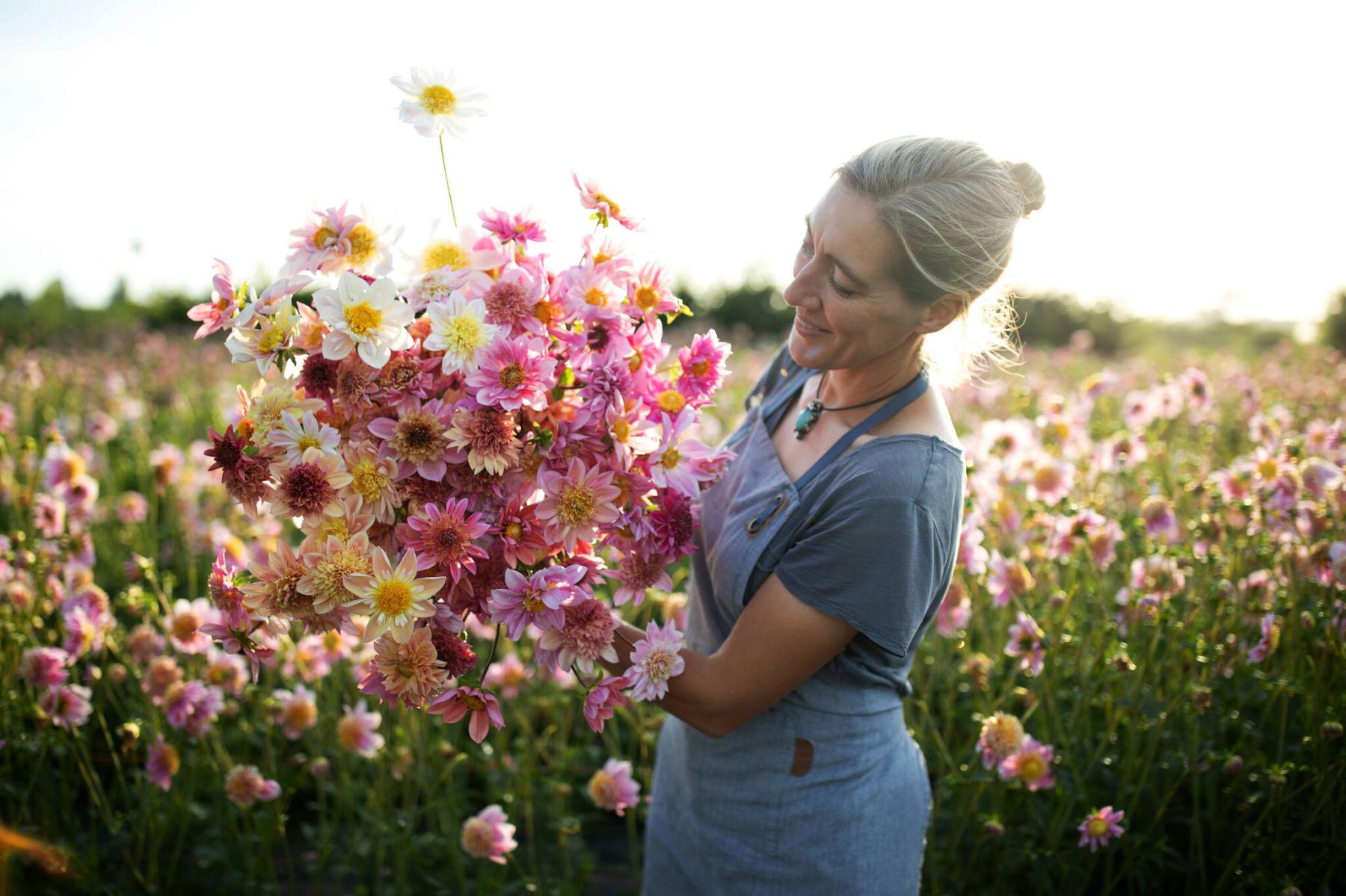  <p>Erin Benzakein with Dahlia Petite Florets &mdash; these soft pastel tones can be grown easily from seed at a huge savings compared to tubers.</p> 