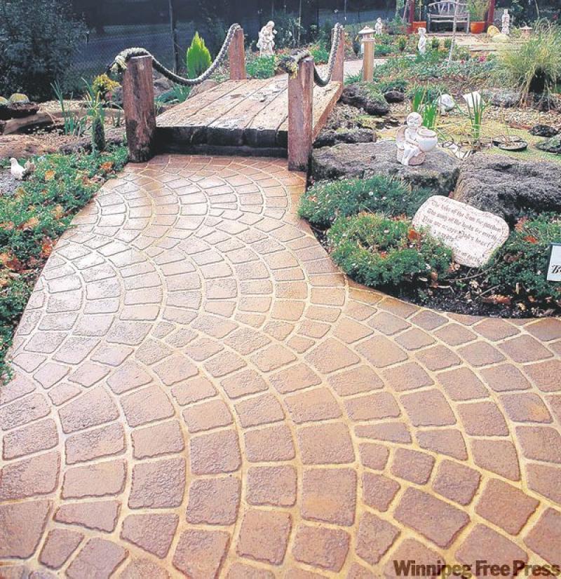 This inviting garden path has been laid using tinted concrete and an innovative stencil system to create the patterned stones.
