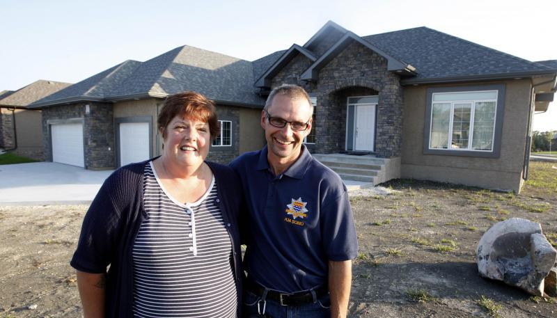Cindy and Dennis Neal outside 34 High Meadow Drive. 