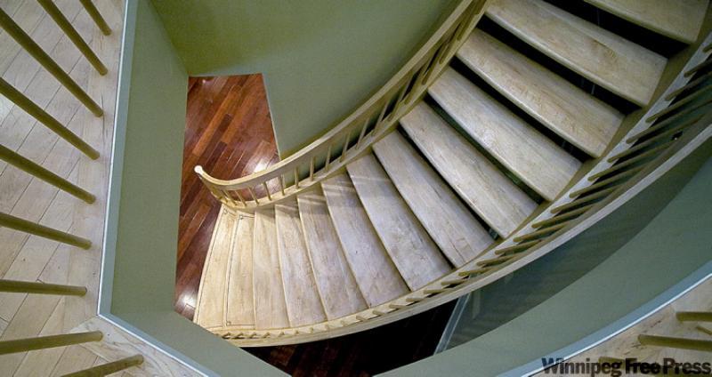 Wendy Wood, below, and her husband Stuart added a curved staircase to their home for some added elegance.