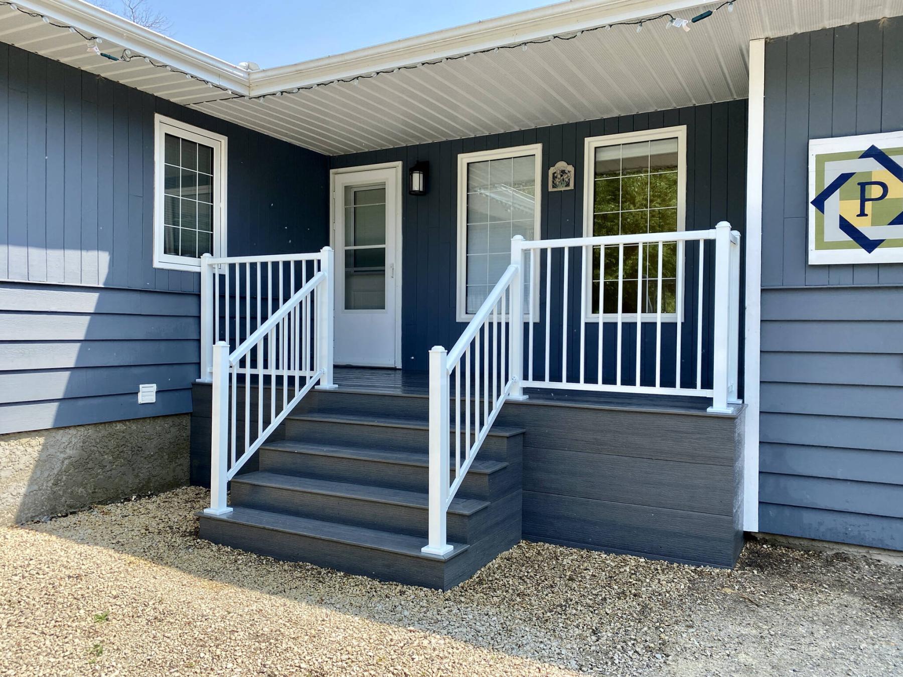 <p>Photos by Marc LaBossiere / Winnipeg Free Press</p>
                                <p>The combination of grey composite and white aluminum railing beautifies the &#010;front entrance.</p> 