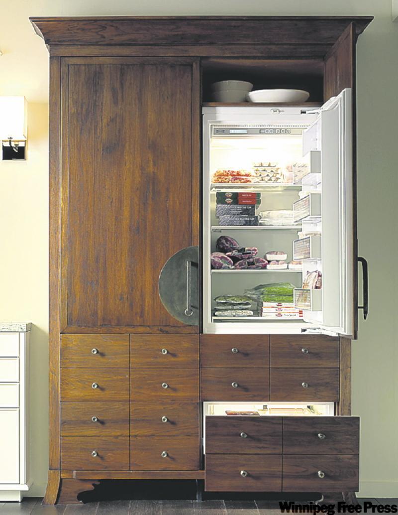 The fridge is enclosed in an armoire-like piece, giving this deluxe kitchen an air of sophistication.