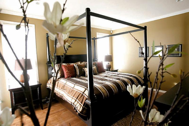 The master bedroom -- in its own private quadrant of the main floor, along with powder room and a den/reading room-- also benefits from the angular design theme.