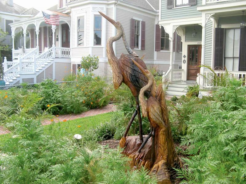 A pair of herons were carved from the trunk of this dead tree, giving it new life.
